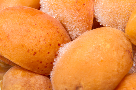 Background of frozen halves of fresh apricotsの写真素材