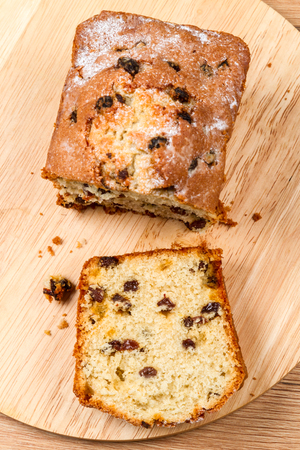 Muffins with raisins on kitchen board top viewの写真素材