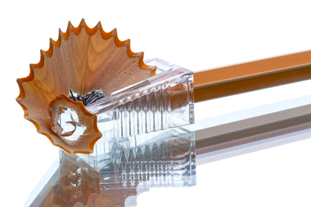 Pencil shavings and sharpener isolated on white backgroundの写真素材
