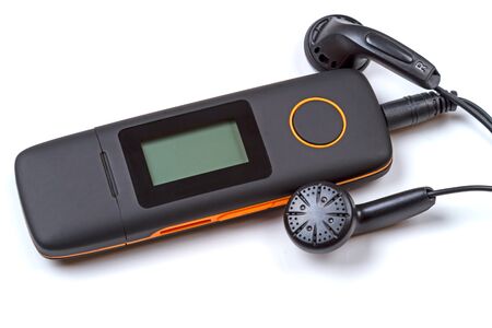 Compact MP3 player and headphones isolated on white backgroundの写真素材