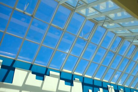 Big glass roof and blue sky on a sunny dayの写真素材