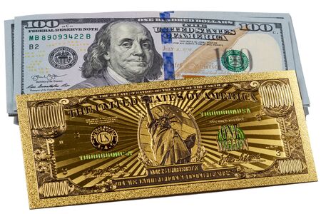 Souvenir American Gold Banknote 1 Million and a pack of 100 dollars on a white backgroundの写真素材