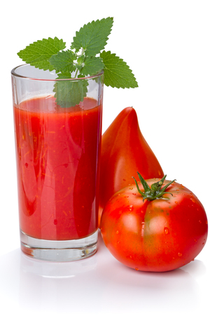 Juice in a glass of fresh tomato and mint leavesの写真素材