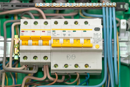 Electric board with circuit breakers. Circuit breaker used on items such as a residential iron, hot water heater, a kitchen oven, or an electric clothes dryer.の写真素材