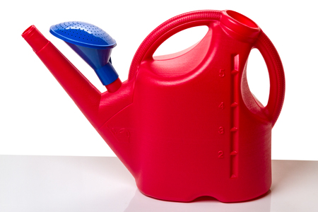 Red plastic watering can on Ð¿ÑÑÑ liters on a white backgroundの写真素材