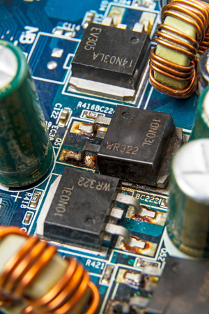 Blown MOSFET transistor 10N03L on a computer motherboard. Manufacturer labeling is absentのeditorial素材