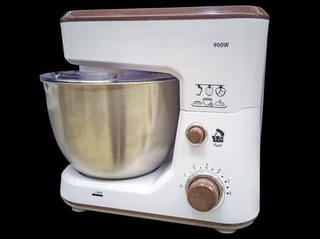 Kitchen universal food mixer isolated on black background