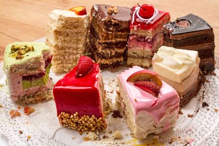Eight Leftover different pieces of cake on a napkinの写真素材