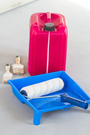 Blue plastic tray, fur roller and primer canister. Construction equipmentの写真素材