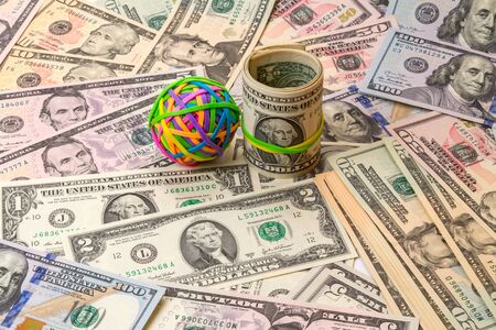 Colored rubber bands for money on dollars backgroundの写真素材