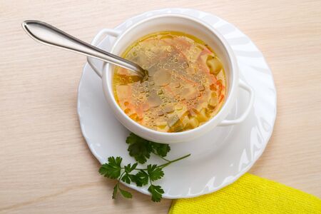 Bowl of soup on a plate Isolated on a white backgroundの写真素材