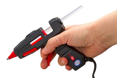 Hand with glue gun isolated on white backgroundの写真素材