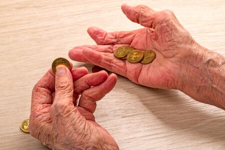 Hands of an old woman and Russian coinsの写真素材