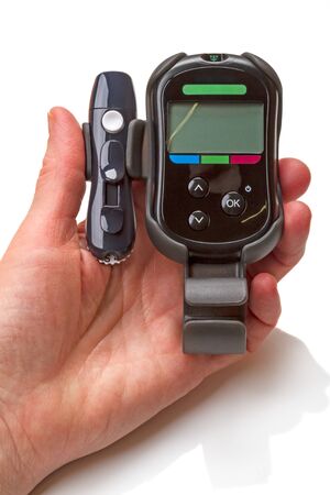 New blood glucose meter in hand. This is a device for controlling glucose at home.の写真素材
