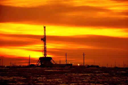 The drilling rig during sunsetの写真素材