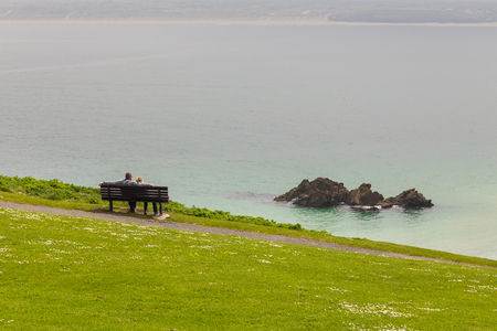 View on the Coast of Cornwall with cliff, path and cloudy sky, Saint Ives, UKの写真素材