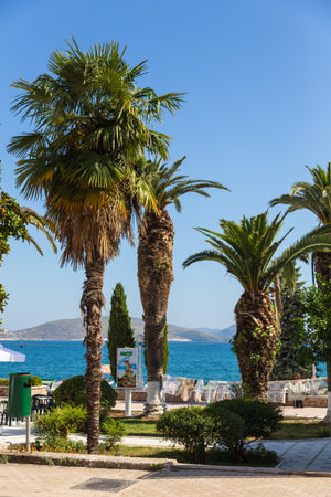 Saranda, Albania- 28 June 2014: Promenade street with palms in Saranda town. Is coastline town, situated on an open sea gulf of the Ionian Sea.のeditorial素材