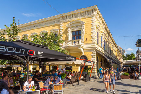 Belgrade, Serbia- 17 August 2014: Restaurants with tables and umbrellas outside Krajla Petra street in the old town. People walking and eating.のeditorial素材