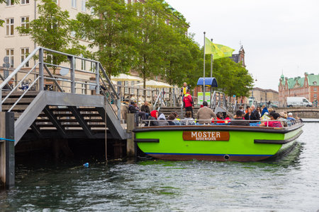 Copenhagen, Denmark- 29 August 2014: Tourists on a cruise barge on the waters of the canal in Copenhagen.のeditorial素材