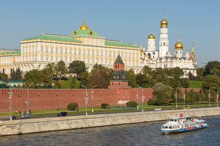 Moscow, Russia- 21 September 2014: Tourist ferry on the Moscow River. Kremlin walls with towers and the Grand Kremlin Palace in the background.のeditorial素材