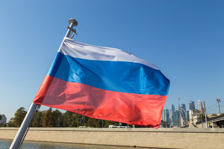 Moscow, Russia- 21 September 2014: Russian flag on the Moscow River in the background, modern buildings along the banks.のeditorial素材