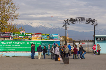 Yelizovo, Russia- 25.09.2014: People waiting at the Petropavlovsk-Kamchatsky Airport arrival gate. Gate with the words welcome. Only airport on the Kamchatka Peninsula.のeditorial素材