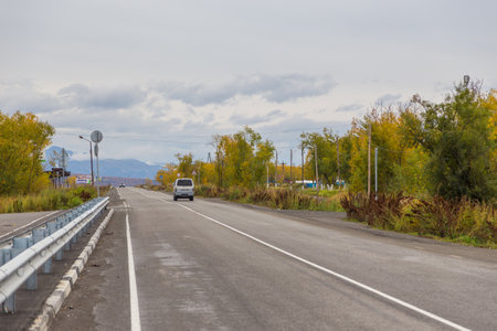 Sokoch, Russia- 27 September 2014: Car on a asphalt road in small village. Road deep into Kamchatka.のeditorial素材