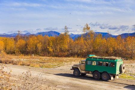 Kamchatka, Unnamed Road, Russia- 27 September 2014: Russian off-road extreme expedition truck with passengers. Gravel road into deep Kamchatka.のeditorial素材