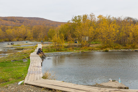 Malkinskiye Hot Springs, Malka, Russia- 27 September 2014: People in a hot springs in the center Kamchatka. Around the mountains in autumn colors.のeditorial素材