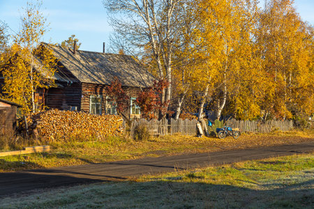Kozyriewsk, Kamchatka, Russia- 28 September 2014: Wooden house in Kozyriewsk on the Kamchatka Peninsula. Wood composition and motor in front of the house.のeditorial素材