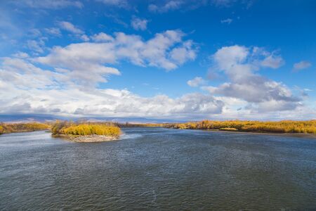 View of the Kamchatka River. Forest in autumn colors, mountain in the background. Kamchatka Peninsula, Russiaの写真素材