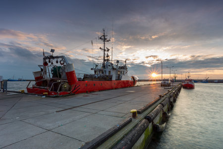 Hel, Poland - 31 January 2015: Cutters moored in the seaport. Small town located on the Hel Peninsula. Breakwater in the background.のeditorial素材