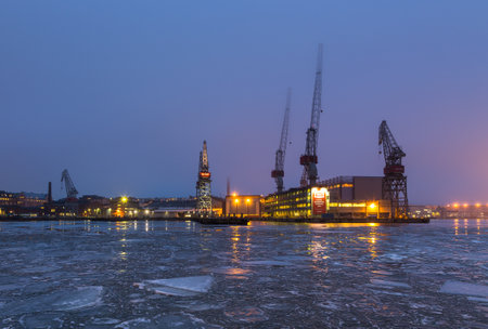 Helsinki, Finland- 27 February 2015: View on cranes in Arctech Helsinki Shipyard. Harbor in a town at night, winter season.のeditorial素材