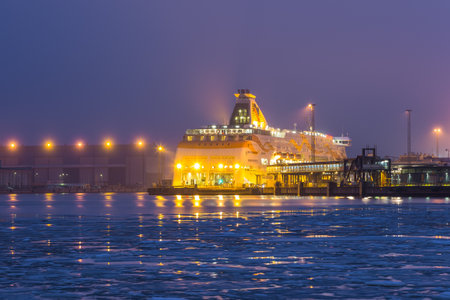 Helsinki, Finland- 27 February 2015: View of the illuminated ferry at Hietalahden pier. Port terminal in the center of Helsinki at night.のeditorial素材