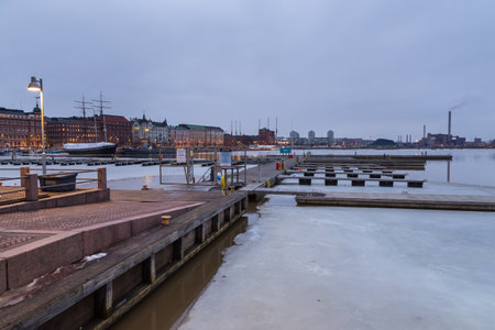Helsinki, Finland- 28 February 2015:View of the yacht and boat marina on the frozen bay. City buildings in the background.のeditorial素材