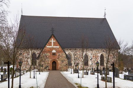 Hollola, Finland- 02 March 2015: View of the medieval, stone Church, Hollolan Kirkko, with cemetery. One of the oldest monuments in Finland. Winter season.のeditorial素材