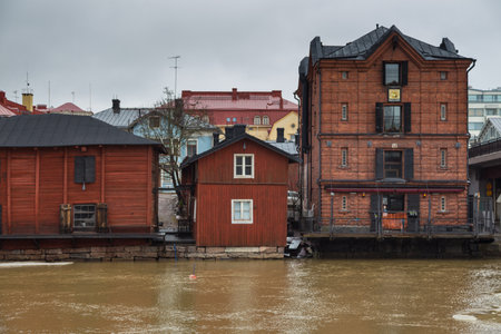 Porvoo, Finland 04 March: 2015: View of the old ocher magazines and historic Old Town, Vanha Porvoo, with medieval, wooden architecture. Frozen Porvoonjoki River in the first plan.のeditorial素材
