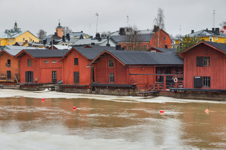 Porvoo, Finland 04 March: 2015: View of the old ocher magazines and historic Old Town, Vanha Porvoo, with medieval, wooden architecture. Frozen Porvoonjoki River in the first plan.のeditorial素材