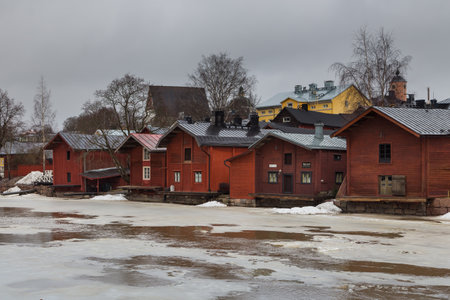 Porvoo, Finland 04 March: 2015: View of the old ocher magazines and historic Old Town, Vanha Porvoo, with medieval, wooden architecture. Frozen Porvoonjoki River in the first plan.のeditorial素材