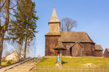 Sominy, Poland- 11 April 2015: Old, wooden, Roman Catholic church of the Mother of God to the Polish Queen. Chapel with the Mother of God in the foreground.のeditorial素材