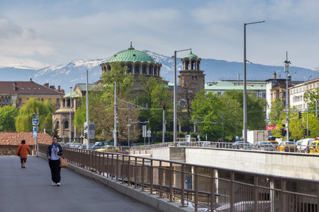 Sofia, Bulgaria- 30 April 2015: View of the Saint Nedelya Church, Eastern Orthodox church the capital of Bulgaria. Women on the bridge, snowy Witosha massif in the background.のeditorial素材