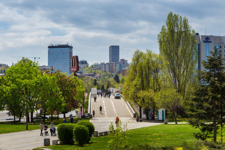 Sofia, Bulgaria- 30 April 2015: Modern buildings at NDK boulevard. Path in the garden, cars on the bridge. Cranes in the background.のeditorial素材