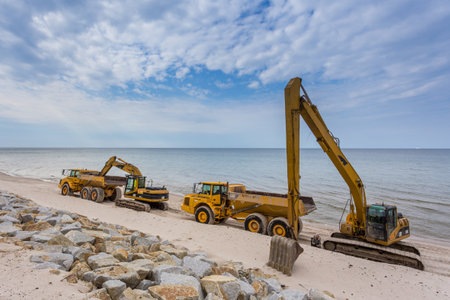 Construction machinery on the beach in Karwia, Poland.のeditorial素材