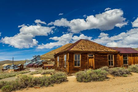 View of the Bodie, ghost town. Bodie State Historic Park. Abandoned wooden houses and Standard Consolidated Mining Company Stamp Mill, California, USA.の写真素材