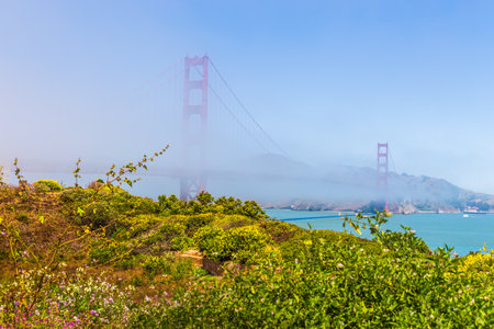 San Francisco, California, USA- 08 June 2015: The Golden Gate Bridge the morning fog. Art Deco...