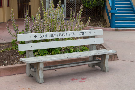 Monterey, California, USA- 09 June 2015: View of the bench at Municipal Wharf. Plants and building in the background.のeditorial素材