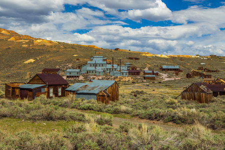 View of the Bodie, ghost town. Bodie State Historic Park. Abandoned wooden houses and Standard Consolidated Mining Company Stamp Mill, California, USA.のeditorial素材