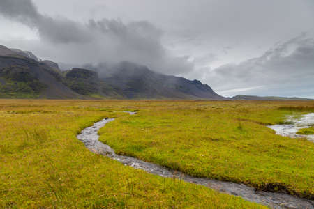 Small river flows out of the Skaftafell Glacier in the Vatnajokull National Park. Southeast Iceland.の写真素材