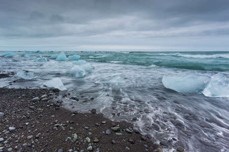View of the Diamond Beach in the south of Iceland. Ice blocks from Jokulsarlon Glacier, Vatnajokull...