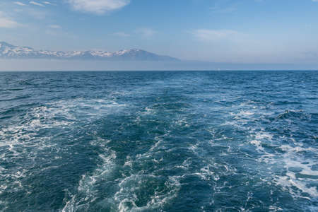 The wake was created behind the Whale Watching boat in the Greenland Sea, Husavik, Iceland.の写真素材